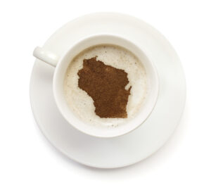 Coffee with foam and powder in the shape of Wisconsin